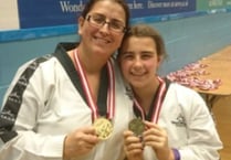 Mother and  daughter in the Tae Kwon Do medals