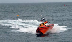 Teignmouth Lifeboat crews in search for missing person and rescue of a person clinging to a buoy