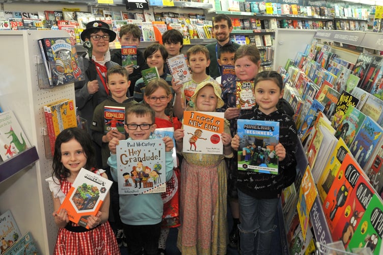 On World Book Day Wolborough Primary School pupils visit the book department of the town's WHSmith store. School council members are pictured here with Jenny Lovick the school's Community Links Coordinator and WHSmith store leader Colin Ryan.
Photo: Steve Pope