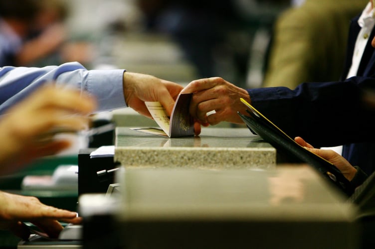 Passports are checked at passport control during the official launch of the UK Border Agency (UKBA) at Gatwick Airport in West Sussex.