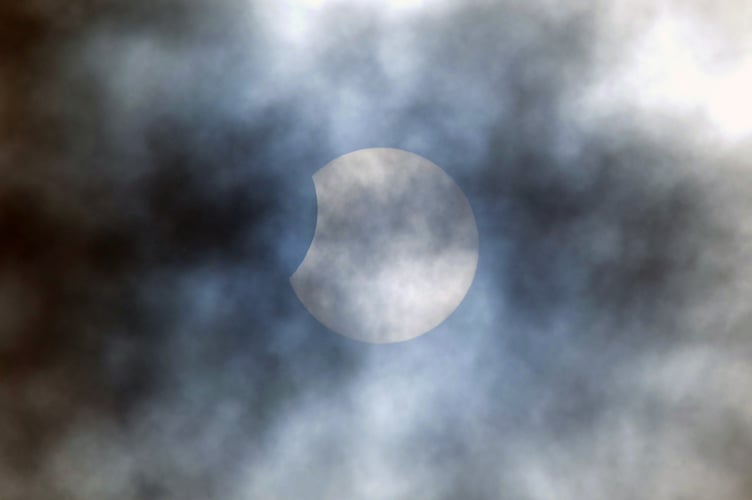 Photo: Steve Pope MDA251022A_SP002
AN AUTUMNAL partial solar eclipse took place this morning (Tuesday, October 25) - but thanks to cloud cover in went unnoticed by most people.
The partial eclipse began at just after 10am this morning when the Moon started to pass in front of the sun and reached maximum eclipse at around 11am.
Despite the scudding cloud cover out photojournalist Steve Pope did manage to grab an image of the celestial event as clouds rolled across the skies.