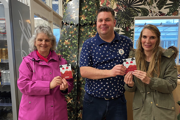 WINNERS: Tesco store manager James Sanders hands over the vouchers to winners Christine Reed (left) and Cherie Glover.