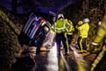 Fire crews help man escape as car ends up on its side