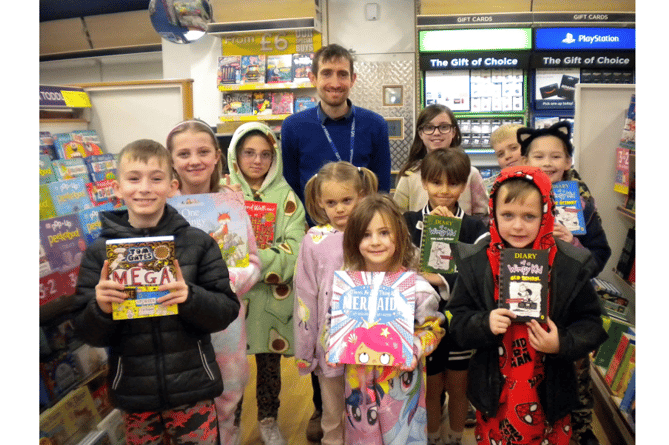 JOY OF BOOKS: Pupils from Wolborough CofE Primary School Council  celebrated World Book Day by visiting Newton Abbot’s WH Smith’s  store where Colin the manager showed them around.