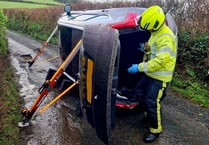 Couple and a dog rescued from overturned car