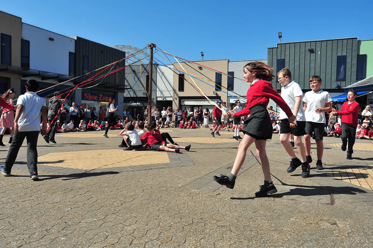 Lords and ladies of the dance – pupils dance around the May Pole in Newton Abbot’s Market Square.