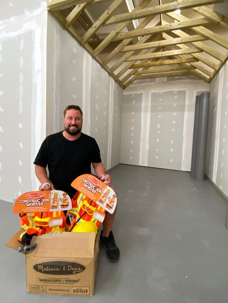 Rhys Heavens starting to unpack play equipment as iTown Newton Abbot takes shape.Picture: NATC (11-7-23)