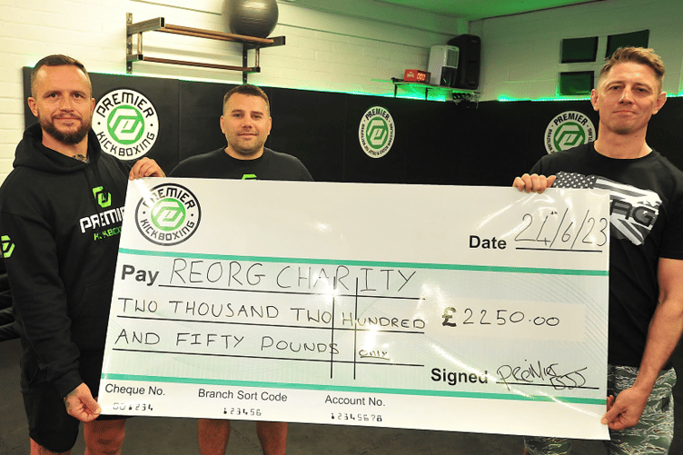Cheque presentation to REORG from Premier Kickboxing Academy. From left: Chris Bunday, Stuart McDowell and REORG founder Sam Sheriff MBE