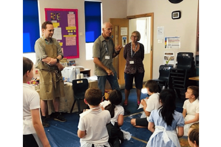 HUMBLING STORY: Roger and Annie Kirk, the founders of the Helen Foundation, explain to the children how many art projects the Foundation funds in the Teignbridge area