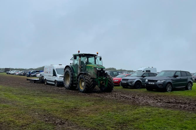 A rather wet and soggy start to Launceston show as a tractor tows a vehicle through the mud
