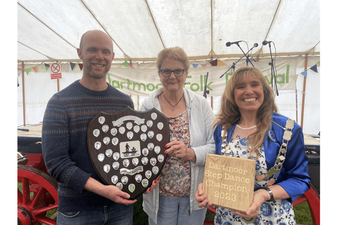 Matt Norman receiving the Dartmoor Step Dance Champion awards from president Shirley Bazeley, centre, and the Mayor of West Devon, right.