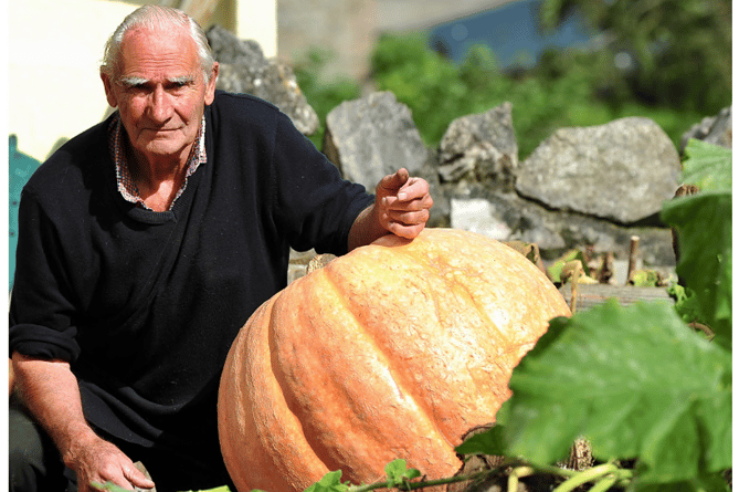 Roger Cloake and one of his larger-than-life pumpkins.