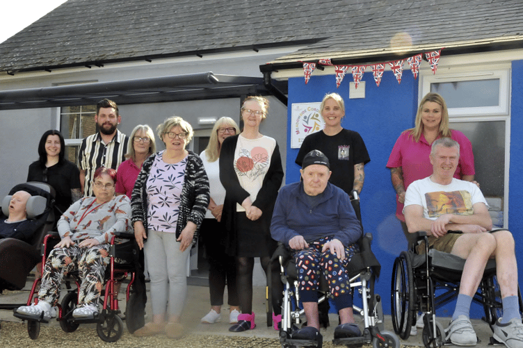 Residents and staff in front of the the newly renovated hall