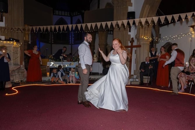 Jeremy and Molly dancing to the disco in the church in which they were married earlier that day.  
