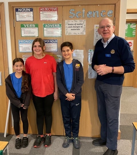 Rotarian Ray Moore with youngsters from the quiz competition
