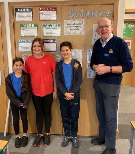 Rotarian Ray Moore with youngsters from the quiz competition
