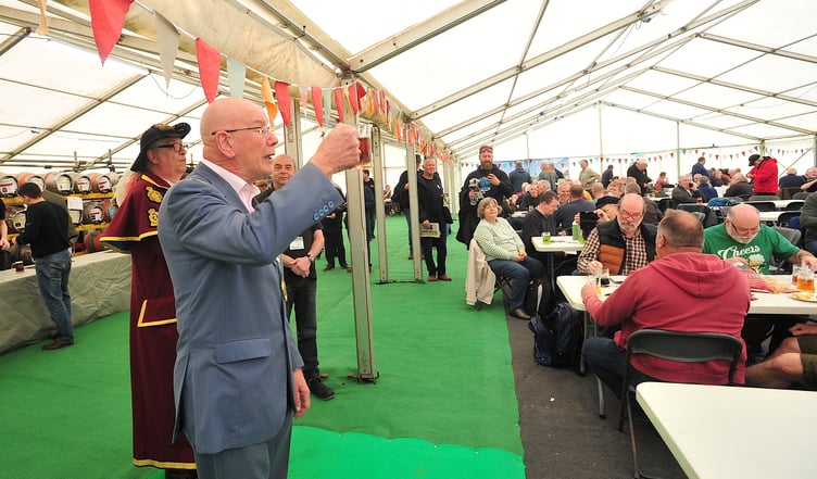 Newton Abbot mayor Cllr David Corney-Walker raises a glass to officially open Maltingsfest 2024