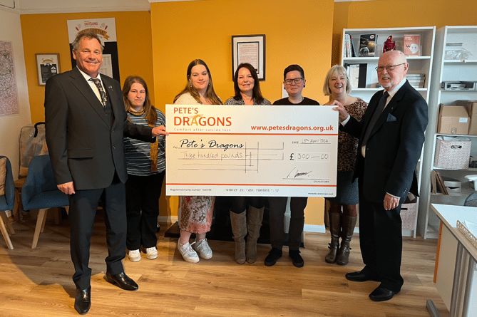 A cheque for £300 was presented to Pete's Dragon by Devon Lodge 1138
