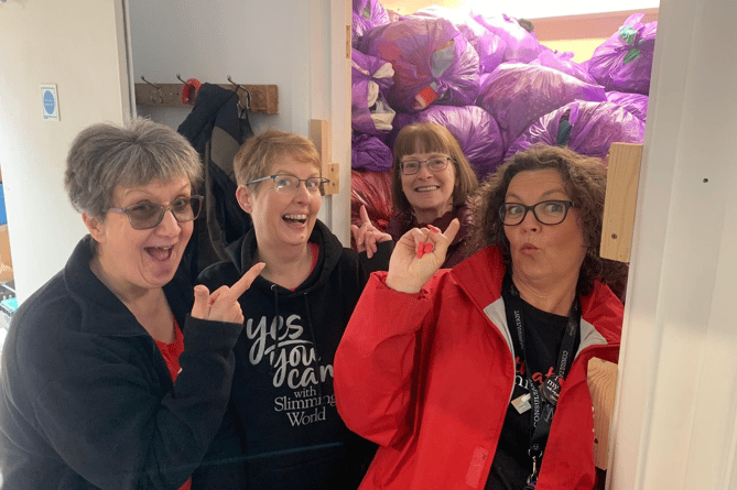 Bags upon bags upon bags! Slimming World group donates clothes to Cancer Research UK