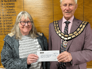 Seventh stint as mayor for councillor as cheque handed to charity 