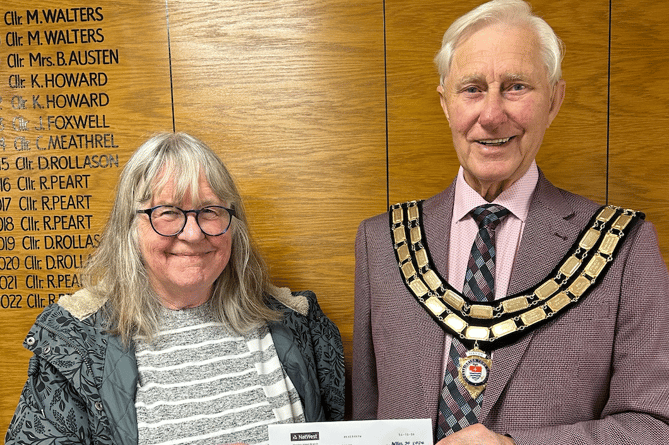 KingsCare's Maggie Bonnell receiving a cheque worth more than £100 from Kingsteignton mayor, Cllr Ron Peart.