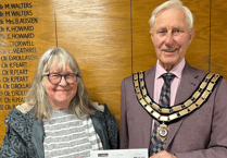 Seventh stint as mayor for councillor as cheque handed to charity 