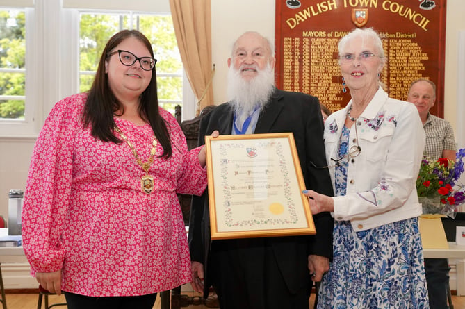 Dawlish's first Honorary Freeman Steve Cunliffe, with wife Caroline, presented with his certificate by outgoing Mayor Rosie Dawson 