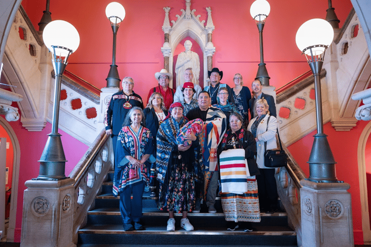 Joset Melting Tallow with the sacred bundle at RAMM, with Siksika delegation and RAMM staff