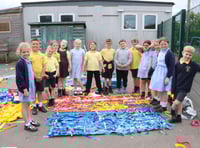 Youngsters decorate playground fencing 