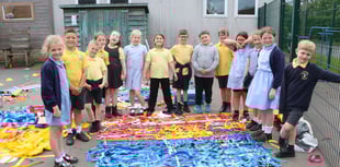 Youngsters decorate playground fencing 
