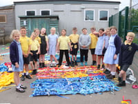 Youngsters decorate playground fencing 