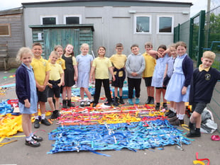 Youngsters decorate playground fencing 