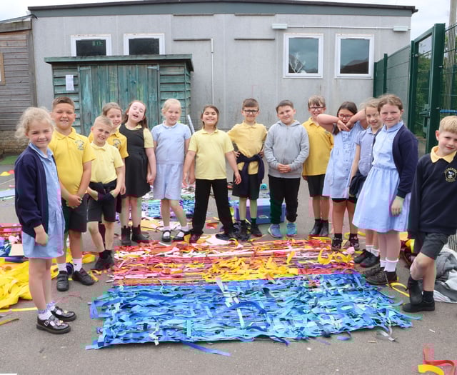 Youngsters decorate playground fencing 