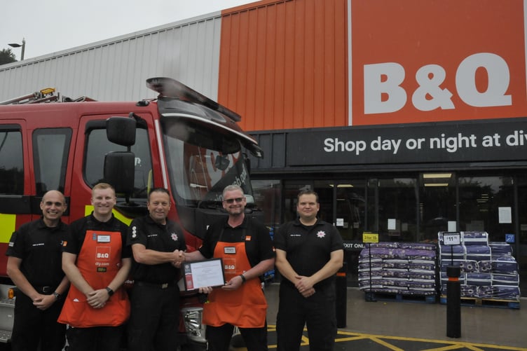Newton Abbot Fire Station presents B&Q with an award in recognition of its long-standing dedication to allowing its workers to act as on-call firefighters