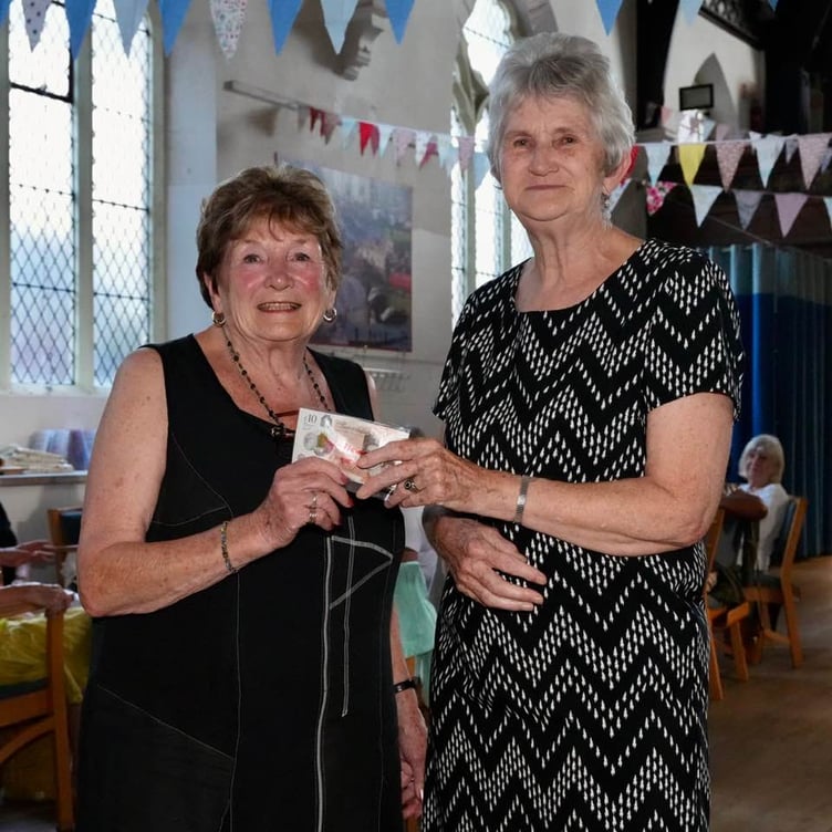 Carole Tamlyn (left) presents donation to Meg Salter. Photo Bob Simpson