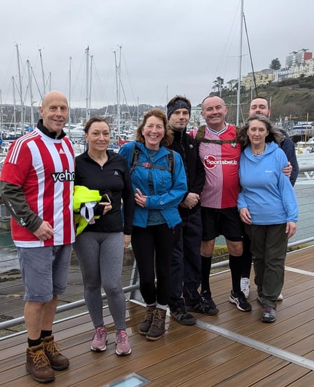 RNLI charity walkers reach their destination at Torquay harbour.