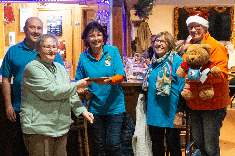 Grace Nickols presenting a cheque to Dawlish Community Transport