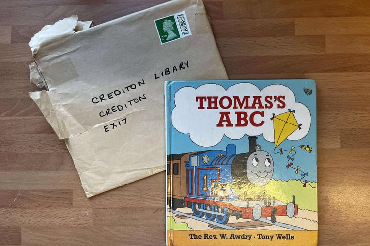 The overdue library book and the envelope in which it was returned to Crediton Library.
