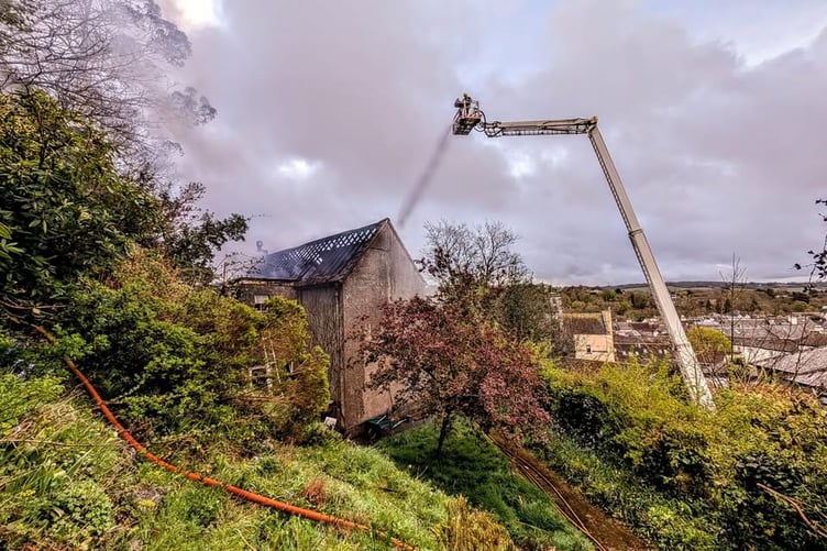 Fire fighters from several stations use a high rise hydraulic ladder is used to tackle a fierce roof fire in a property on Kilworthy Hill, Tavistock.