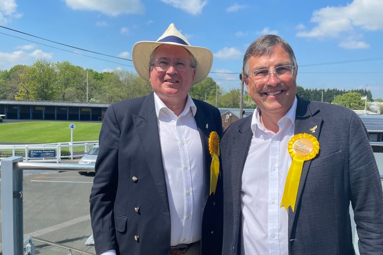 Martin Wrigley MP (r) celebrating David Cox's Liberal Democrat win in Teignmouth at Newton Abbot Racecourse today.