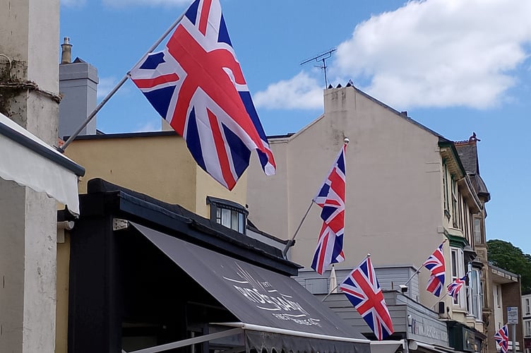Flags flying outside Dawlish shops for VE Day. photo NOREEN GOODCHILD
