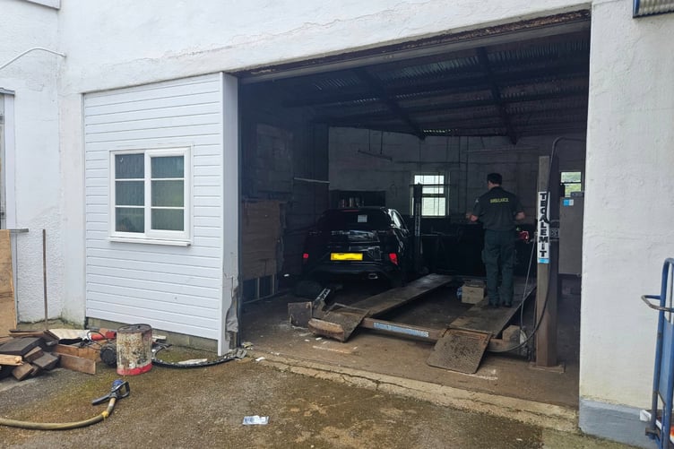 The car came to a rest inside a commercial garage