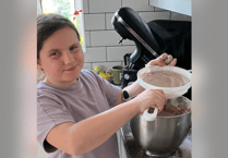 Youngster Red is at it again as she prepares for charity cake sale