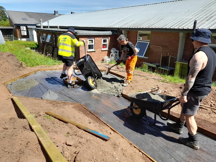 Westbank Community Allotment - three volunteers from Kier laying the new pathway (photo supplied by Kier)