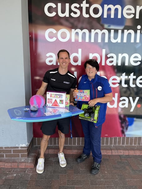 Simon Gibbs, vice principal at Glendinning Academy, receives prizes donated by Bev Perrins, Newton Abbot Tesco Superstore’s Community Champion.