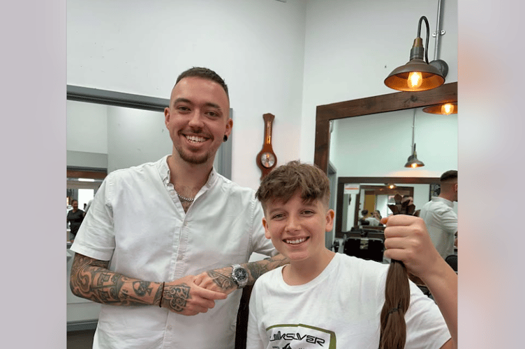 The Groom Room's George, left, cut Tyler's hair