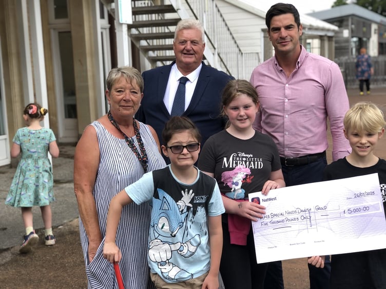 Claire Coombs, Team leader AIMS, with Paul Beatty, Charity Steward St Michaels Lodge Dawlish, and Alex Pemberton, Master of St Michael's Lodge with some of the children who wil benefit from the donation