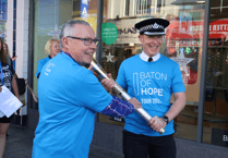 Senior police officer walks with Baton of Hope