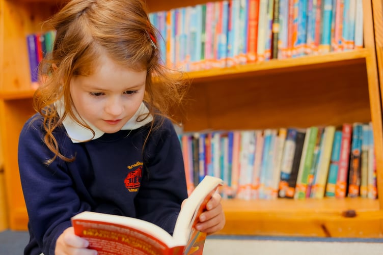 Broadhempston Primary School pupil Florence Kingdon in the school library. Photo Dannie Carter