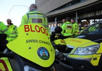 South West Blood Bike charity celebrating saving NHS £1million